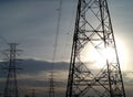 silhouette of steel framework of high voltage pylon tower with electric transmission power lines and evening sunset sky Royalty Free Stock Photo