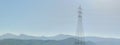 High voltage post or High voltage tower on background mountains with Wind turbines Royalty Free Stock Photo