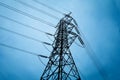 Silhouette of high voltage power lines on blue background.