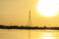 High voltage post on landscape view at morning with Sky yellow and river background Royalty Free Stock Photo