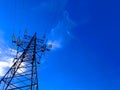 High voltage post or power transmission tower agains blue sky. Silhouette of electricity post and high-voltage power Royalty Free Stock Photo