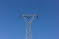 High voltage post, power transmission tower against blue sky Royalty Free Stock Photo