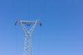 High voltage post, power transmission tower against blue sky Royalty Free Stock Photo