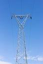 High voltage post, power transmission tower against blue sky Royalty Free Stock Photo