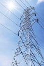 High voltage post with sunlight blue sky background Royalty Free Stock Photo