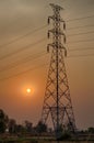 High voltage post tower and power line on sunset sky background Royalty Free Stock Photo