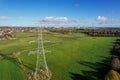 High voltage post,High voltage tower sky field grass housing esate aerial drone view Royalty Free Stock Photo