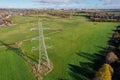 High voltage post,High voltage tower sky field grass housing esate aerial drone view Royalty Free Stock Photo