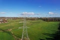 High voltage post,High voltage tower sky field grass housing esate aerial drone view Royalty Free Stock Photo