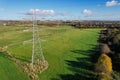 High voltage post,High voltage tower sky field grass housing esate aerial drone view Royalty Free Stock Photo