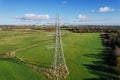 High voltage post,High voltage tower sky field grass housing esate aerial drone view Royalty Free Stock Photo