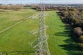 High voltage post,High voltage tower sky field grass housing esate aerial drone view Royalty Free Stock Photo