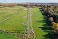 High voltage post,High voltage tower sky field grass housing esate aerial drone view