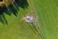 High voltage post,High voltage tower sky field grass housing esate aerial drone view Royalty Free Stock Photo