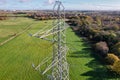 High voltage post,High voltage tower sky field grass housing esate aerial drone view Royalty Free Stock Photo