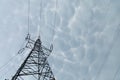 A steel power transmission pole against a backdrop of storm clouds. Royalty Free Stock Photo