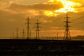 High voltage power line in a field at sunset on winter Royalty Free Stock Photo