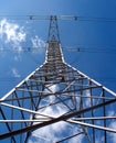 High-voltage power line metal pillar over blue sky vertical view Royalty Free Stock Photo