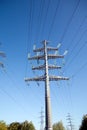 High-voltage power line metal prop over clear cloudless blue sky Royalty Free Stock Photo