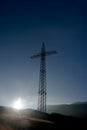 High-voltage power line pylon and morning sun Royalty Free Stock Photo