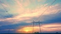 High-voltage power lines against the backdrop of the setting sun in an open area aerovideo.