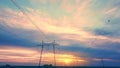 High-voltage power lines against the backdrop of the setting sun in an open area aerovideo