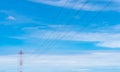 High voltage power lines against blue sky. High voltage electric transmission tower. Electricity pylon and electric power Royalty Free Stock Photo