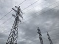 High voltage power lines on background of sky. Towers power lines against a cloudy sky background. Electricity transmission pylons Royalty Free Stock Photo