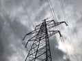 High voltage power lines on background of sky. Towers power lines against a cloudy sky background. Electricity transmission pylons Royalty Free Stock Photo