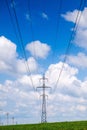 High voltage power lines and cloudy blue sky Royalty Free Stock Photo