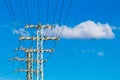 High voltage power lines and electric transmission pylon with blue sky background Royalty Free Stock Photo