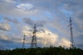 High voltage power lines with electricity pylons against the background of the evening cloudy sky. Royalty Free Stock Photo