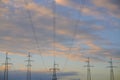 High voltage power lines with electricity pylons against the background of the evening cloudy sky. Royalty Free Stock Photo