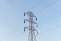 High-voltage power lines electricity transmission pylon on blue sky background Royalty Free Stock Photo