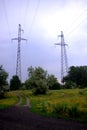 High-voltage power lines passing over the forest glade Royalty Free Stock Photo