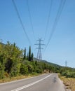 High voltage power lines and pylons on blue sky background Royalty Free Stock Photo