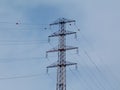 High voltage power lines and steel electrical tower in low angle abstract view. Royalty Free Stock Photo