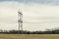 High Voltage Power Lines Stretching Across a Field Royalty Free Stock Photo