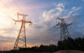 High-voltage power lines at sunset or sunrise. High voltage electric transmission tower