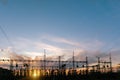 High-voltage power lines at sunset or sunrise. High voltage electric transmission tower