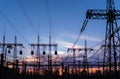 High voltage power lines at sunset. Thermal power plant. High-voltage transformer substation Royalty Free Stock Photo