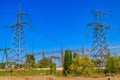 High voltage power lines towers on blue sky background Royalty Free Stock Photo