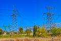 High voltage power lines towers on blue sky background Royalty Free Stock Photo