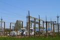 High-voltage power lines and voltage transformer blocks on a blue sky. Electric power substation Royalty Free Stock Photo