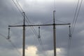 High-voltage power lines and a transformer with wires against the grey cloudy sky Royalty Free Stock Photo