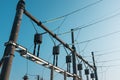 High voltage power lines with voltage against a blue sky. Live substation