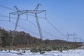 High-voltage power lines in winter time. High voltage electric transmission tower energy pylon Royalty Free Stock Photo