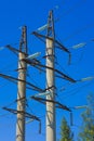 High voltage power pylons against blue sky Royalty Free Stock Photo