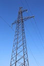 High voltage power pylons against blue sky Royalty Free Stock Photo
