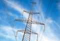 A high voltage power pylons against cloudy sky Royalty Free Stock Photo